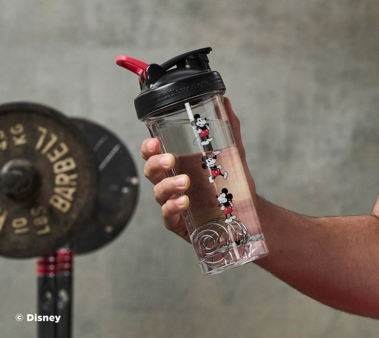 pro-series-y7 Mickey_Mouse_Protein_Shaker_Bottle_Being_Held_In_the_Gym.jpg